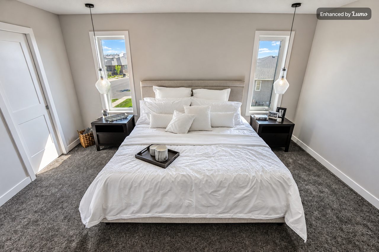 The same bedroom after Lumo: brighter, with clear views out the windows