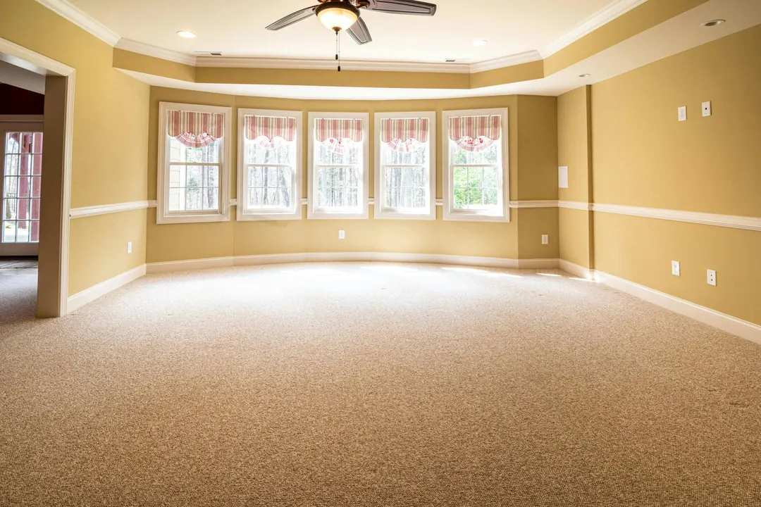 The same living room, empty, before staging
